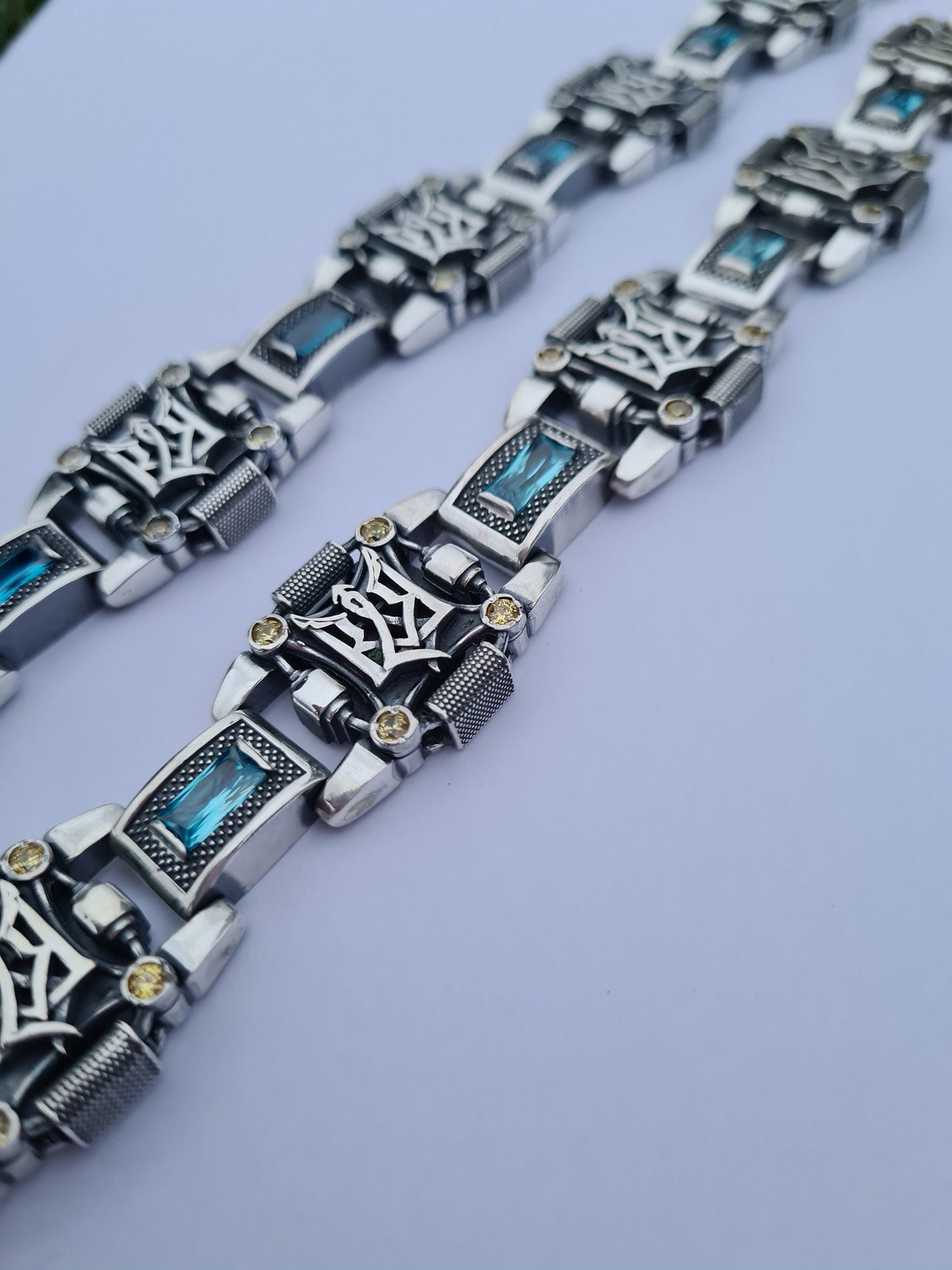 Two bracelets with tridents with stones