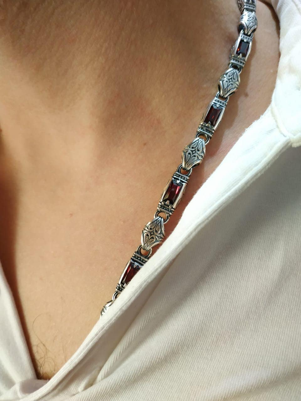 men's jewelry with garnet and gothic ornament on a man