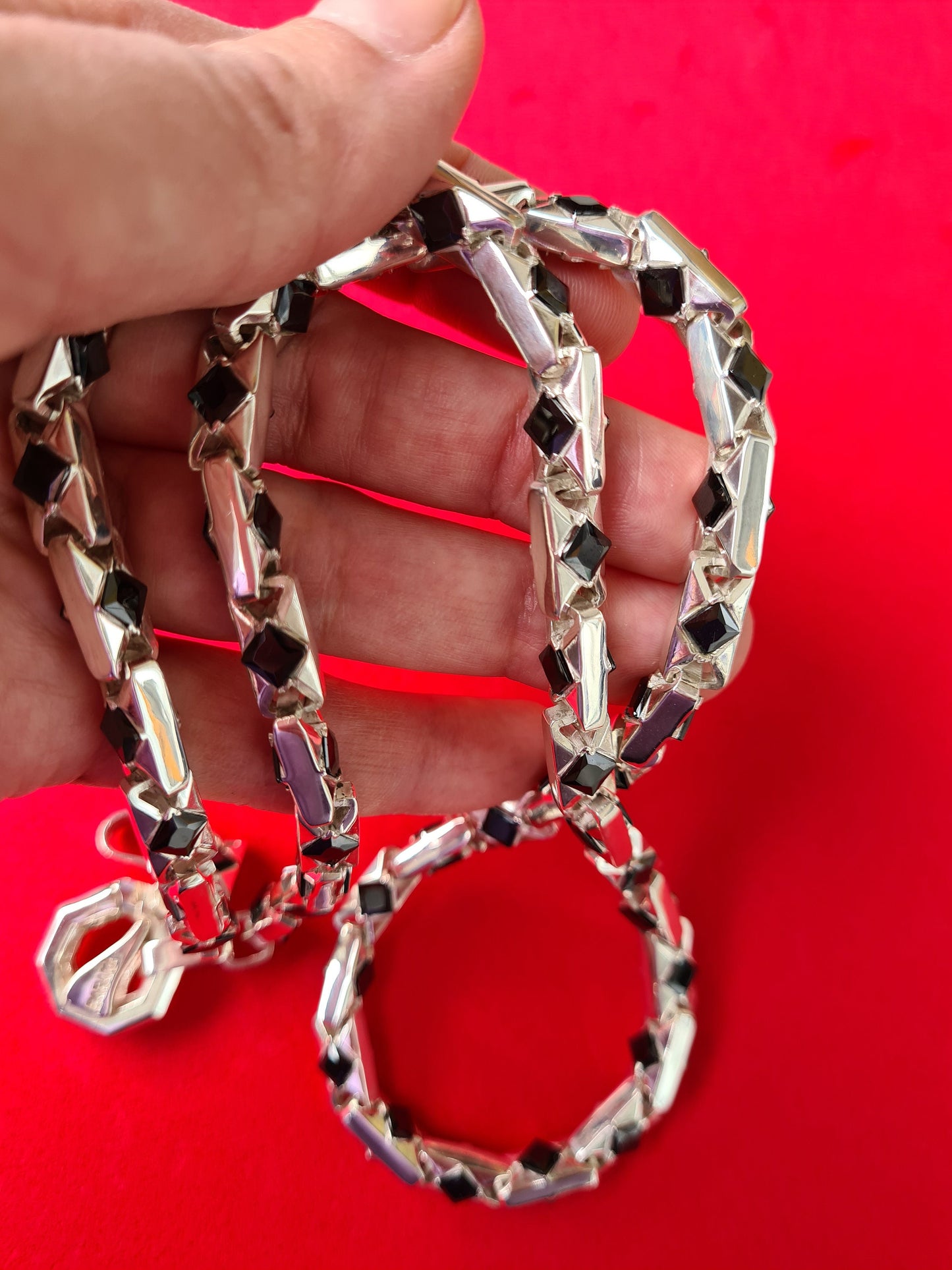 men's silver necklace with agates on a red background