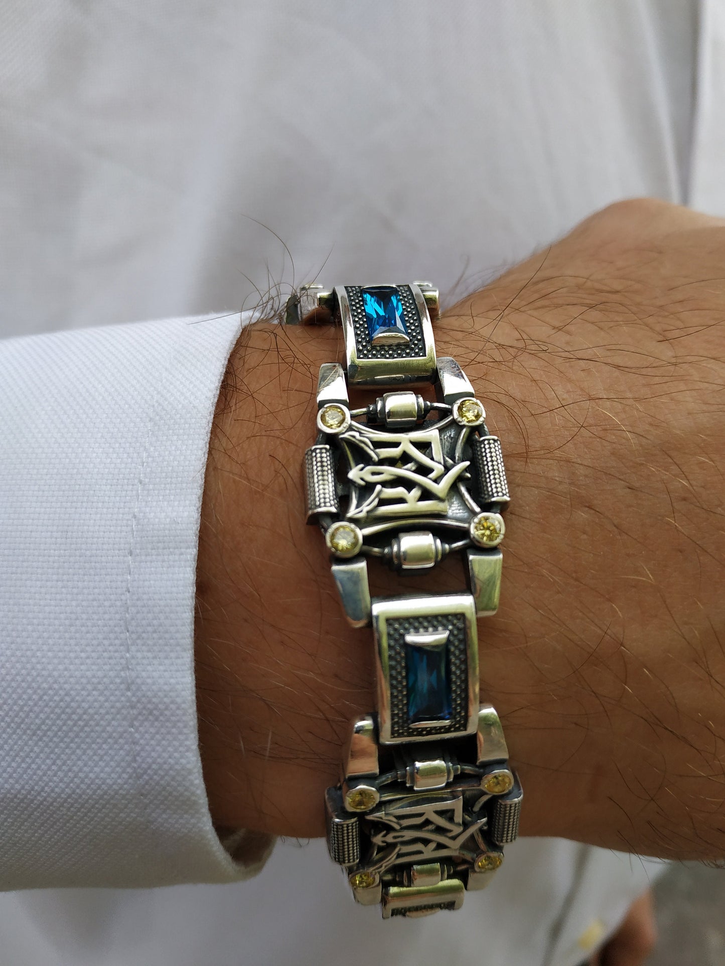 Silver bracelet with trident on hand