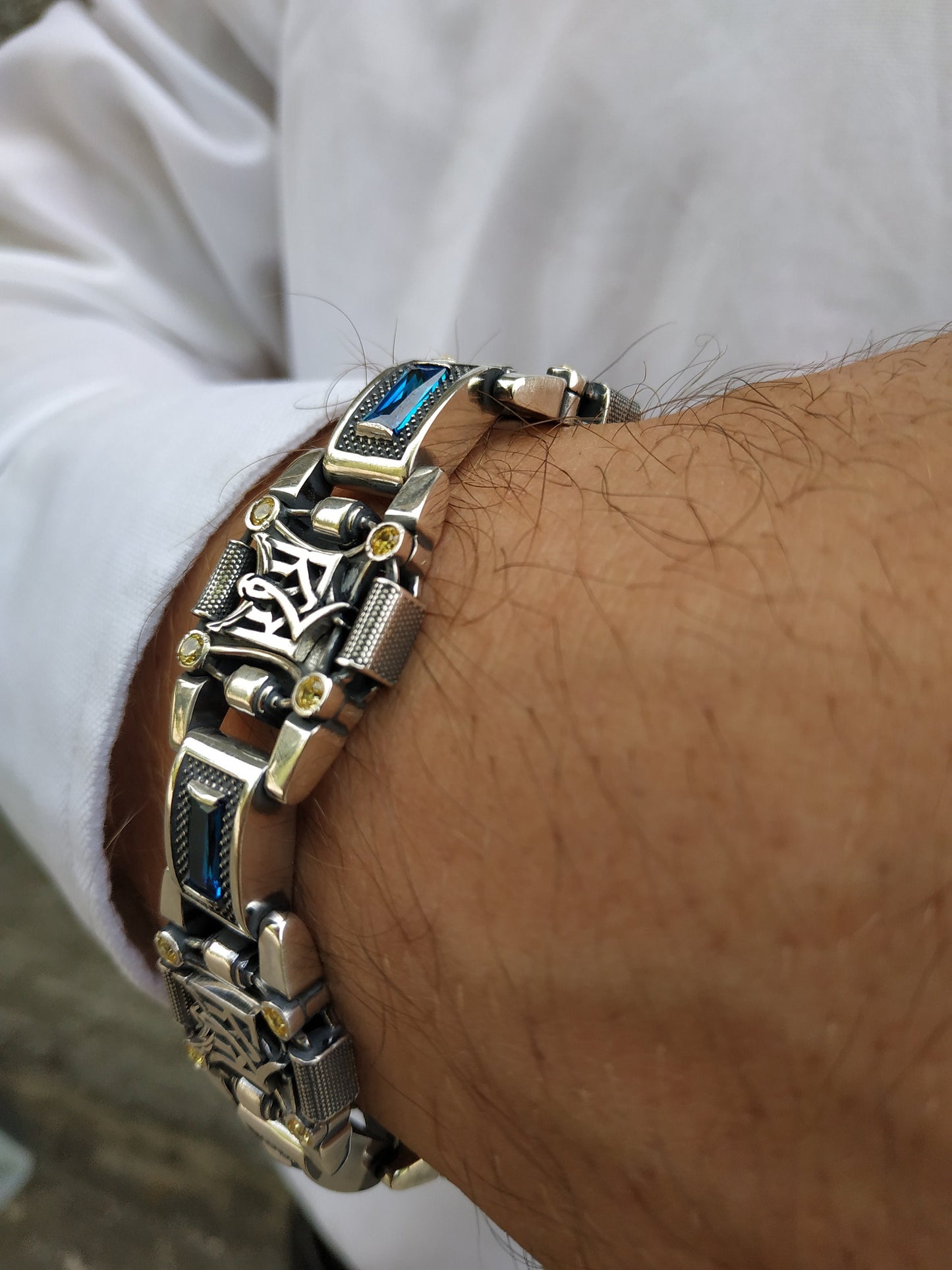 Silver bracelet with trident, yellow and blue inserts