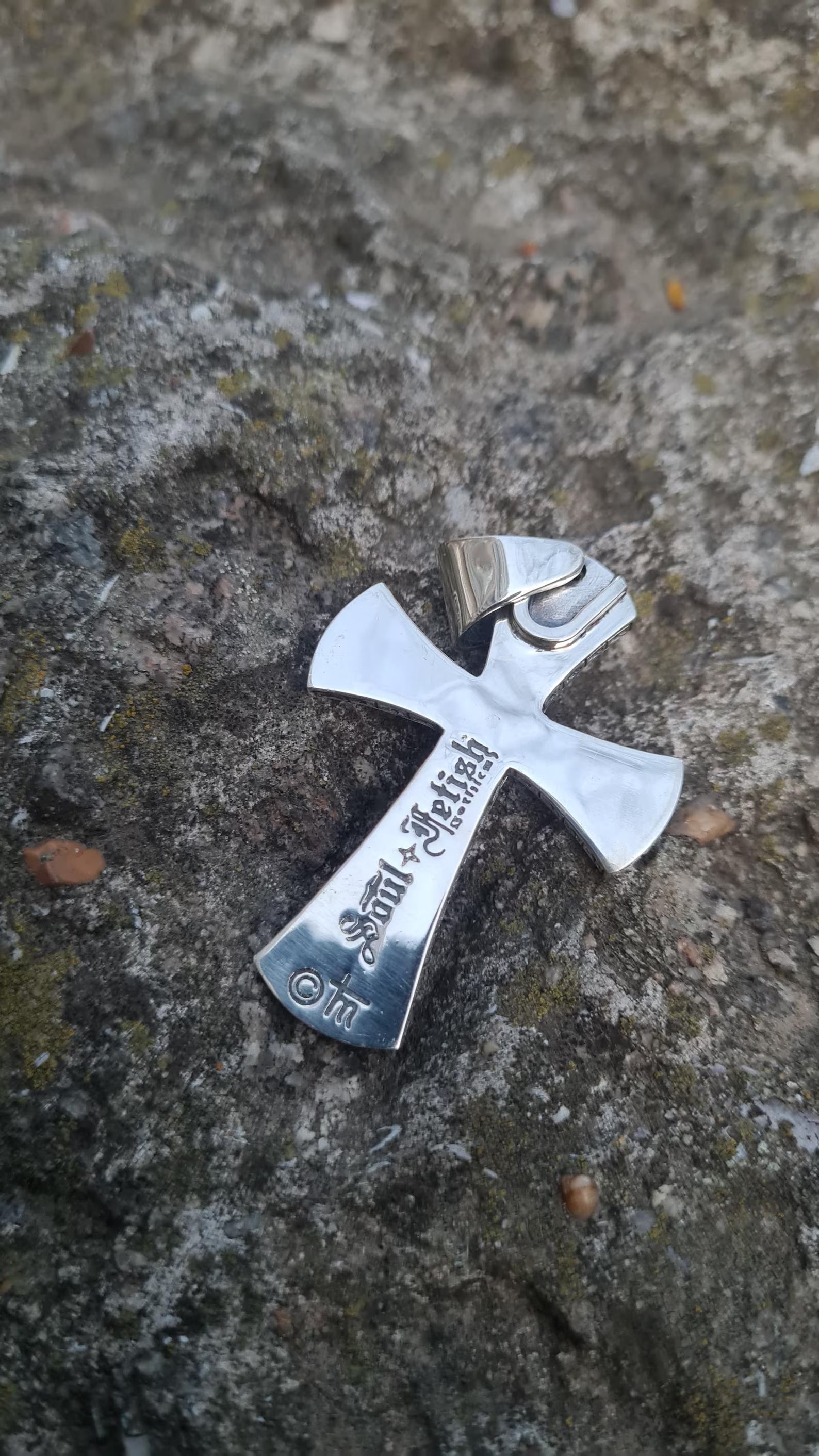 Cross-shaped black onyx stone set in silver gothic design