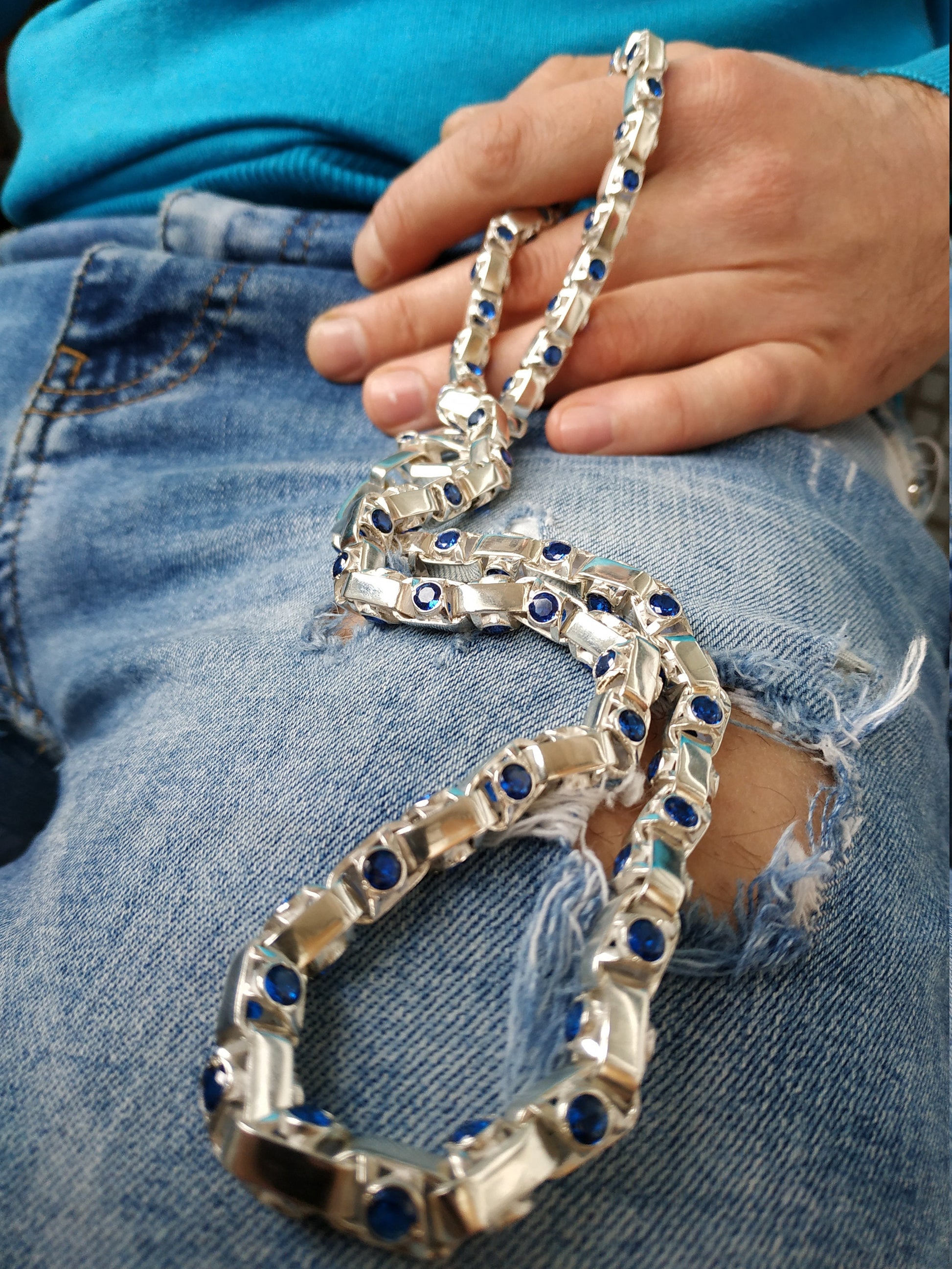 Silver chain with blue inserts close-up