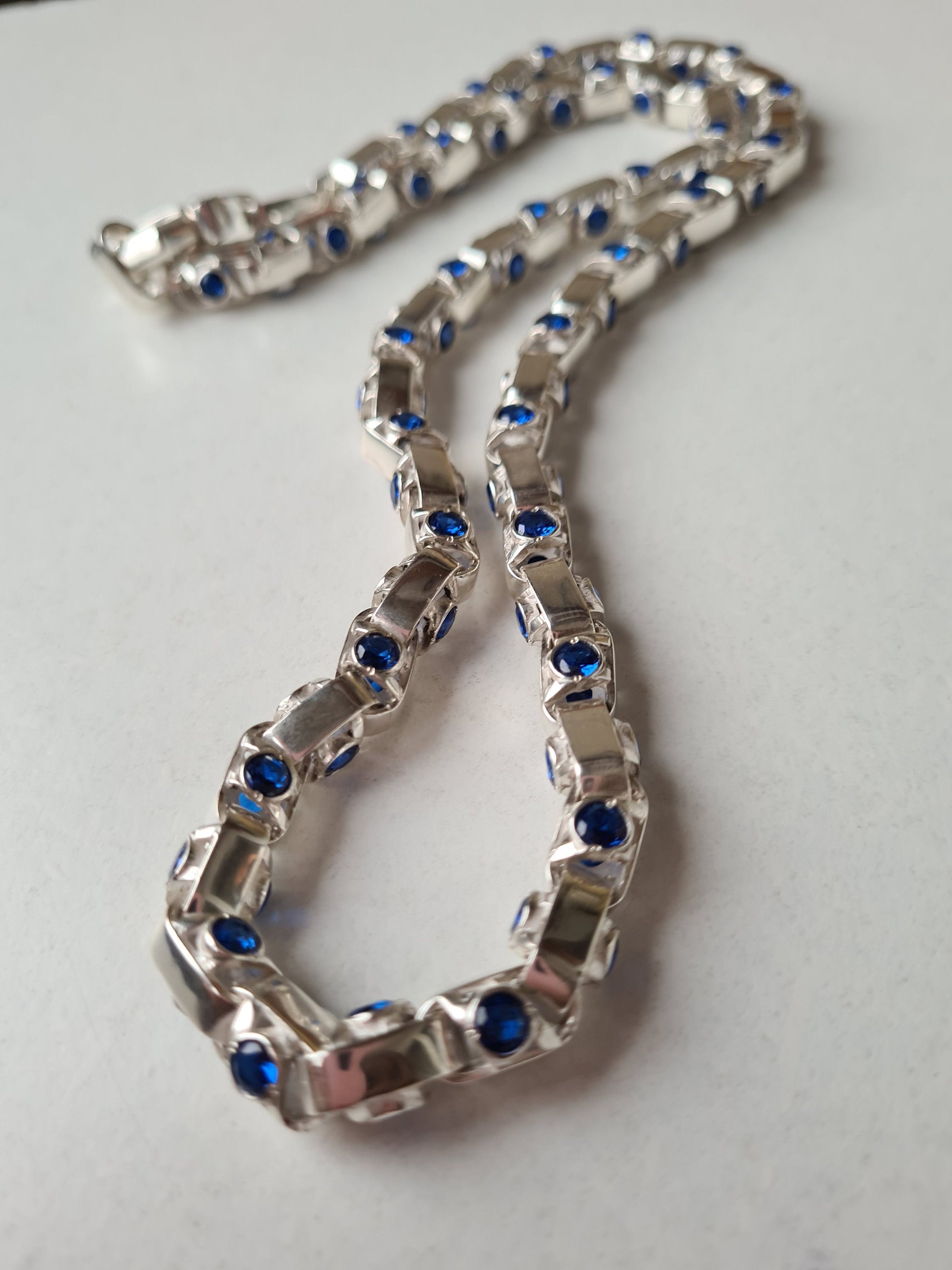 Silver chain details with bright blue accents