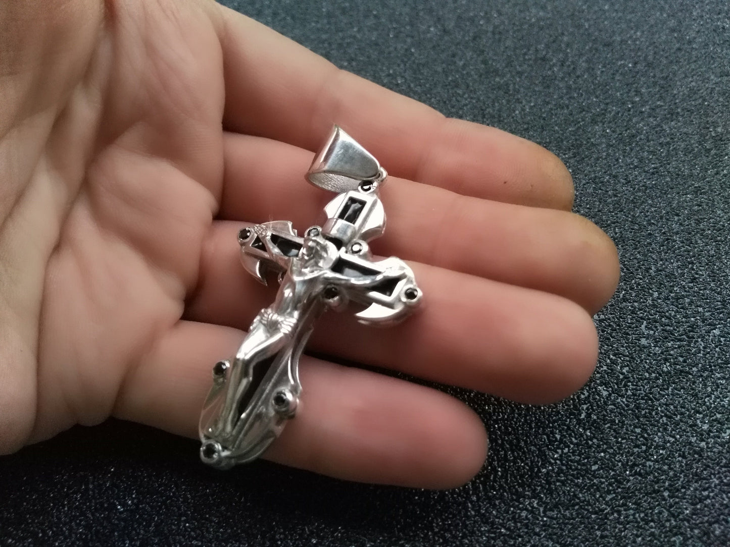 Cross pendant in hand