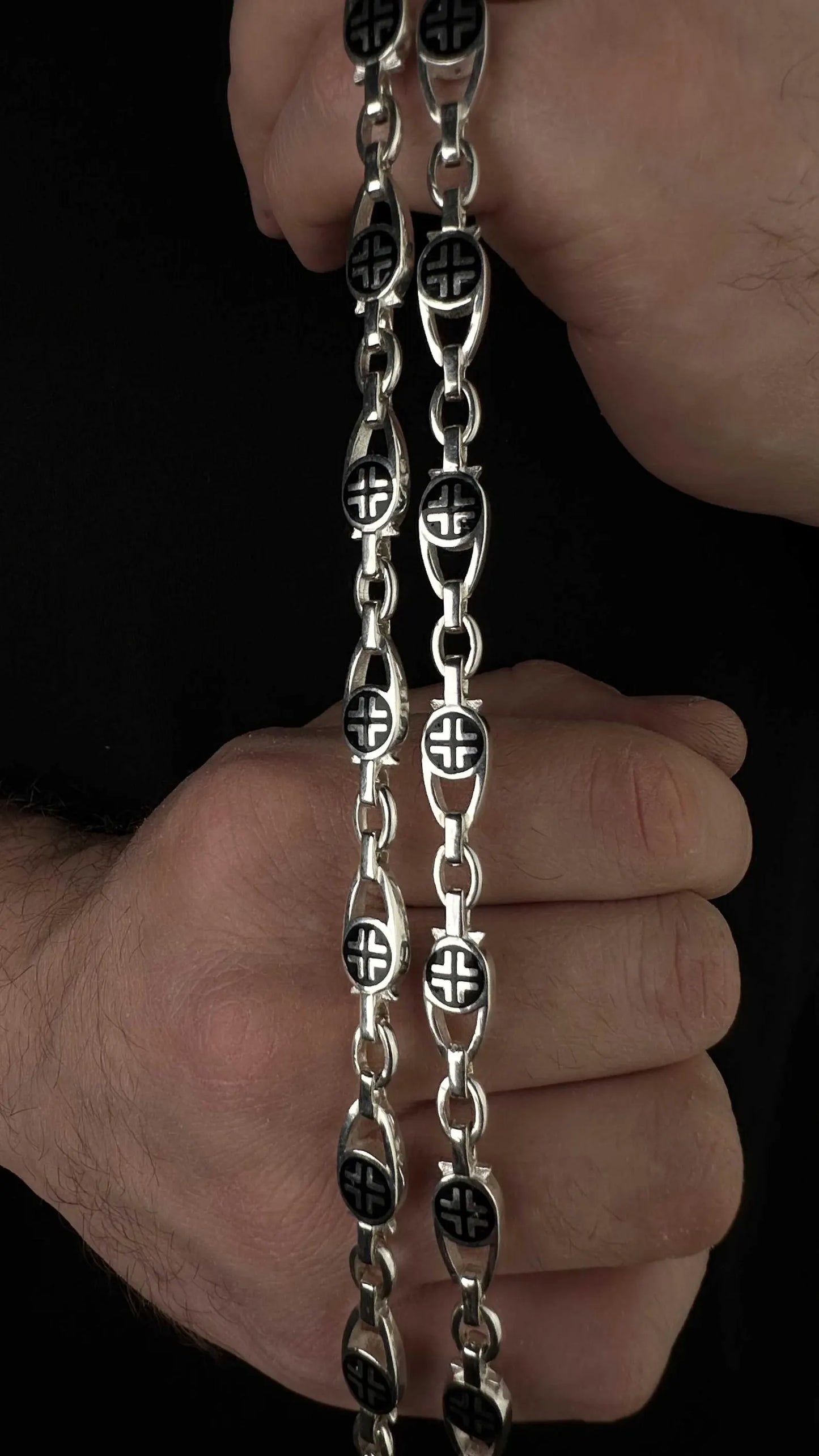 Details of links of chain made of silver 925 with black enamel and crosses