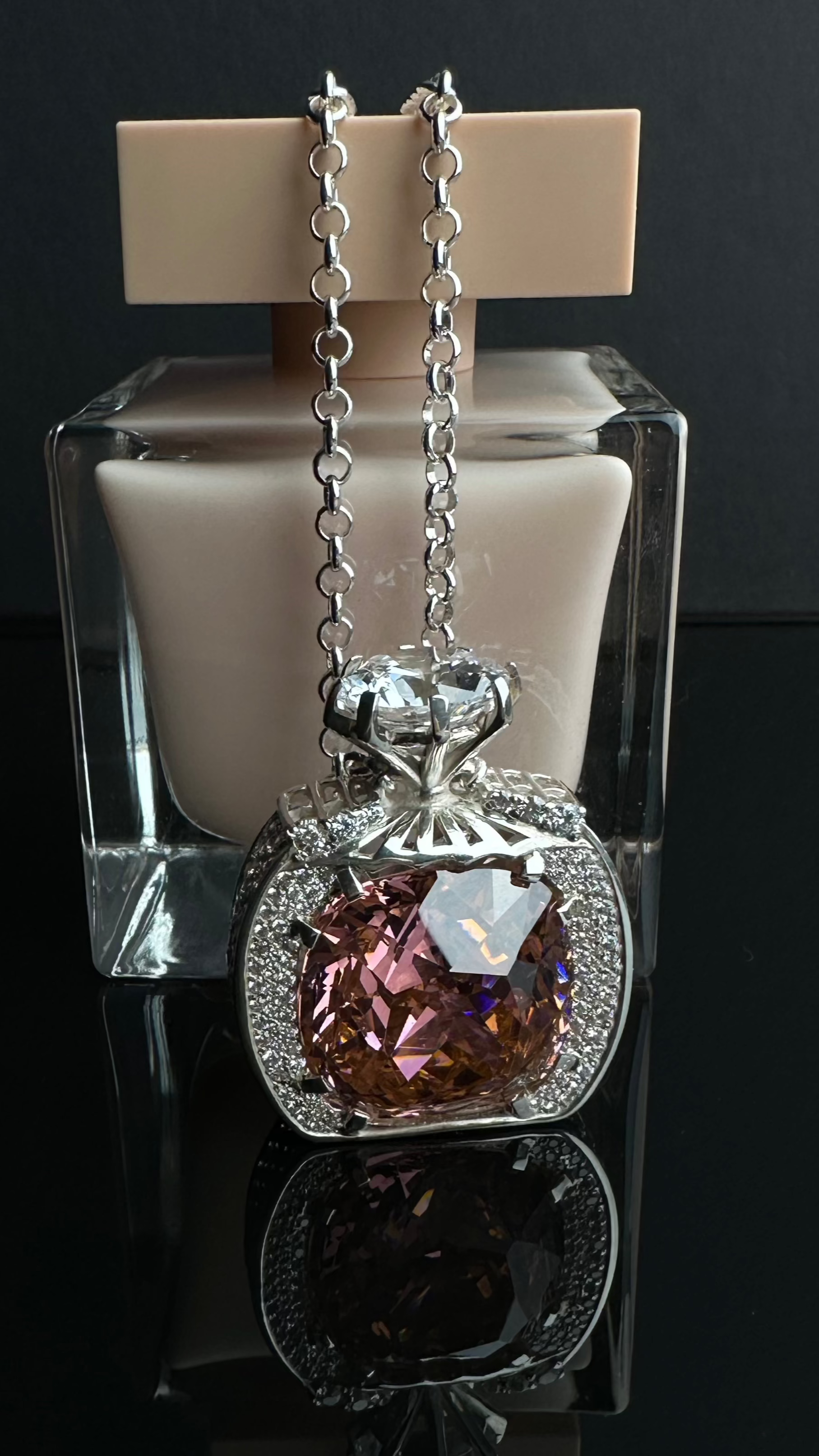 Pendant in the form of a miniature perfume bottle with a large sparkling stone on an elegant chain